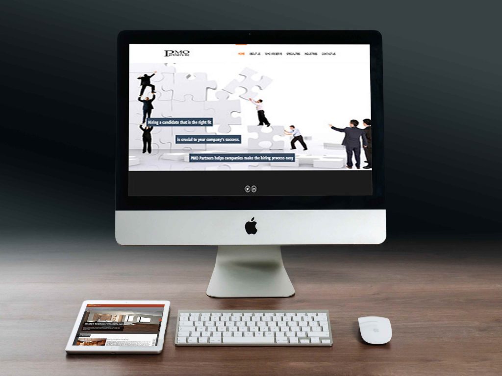 PMO Partners website with a puzzle-piece banner about hiring, on a desktop monitor with a tablet beside it